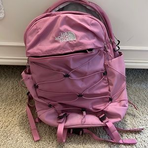 Pink and silver north face backpack